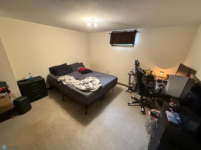 bedroom featuring a textured ceiling and concrete flooring