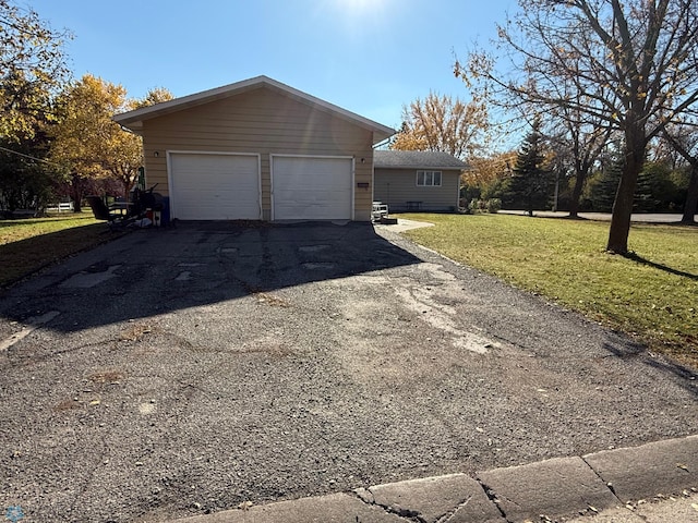 view of home's exterior featuring a yard and a garage