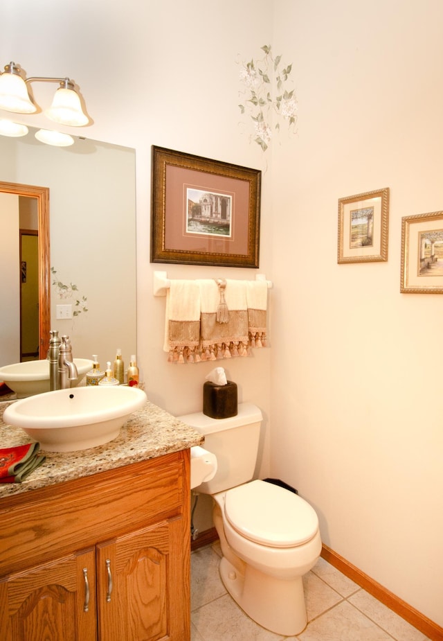 bathroom with vanity, toilet, and tile patterned floors