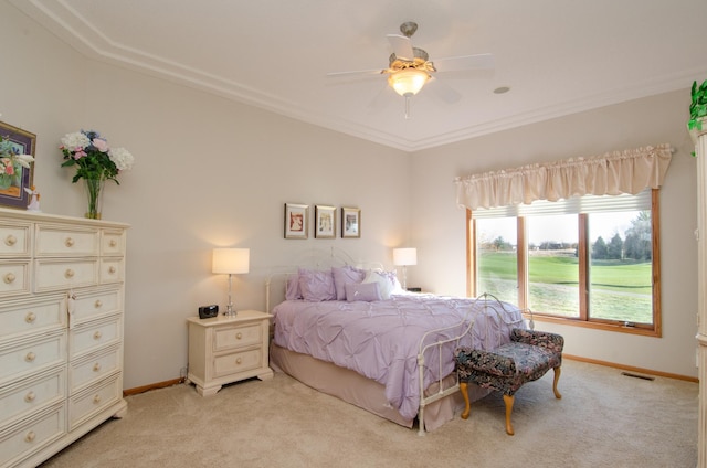 carpeted bedroom with ceiling fan and ornamental molding