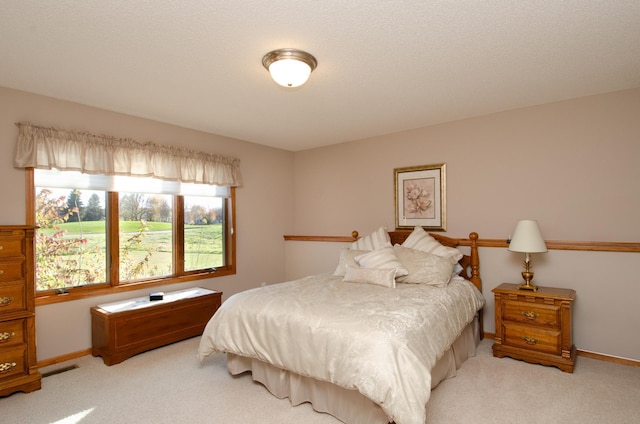 carpeted bedroom with a textured ceiling