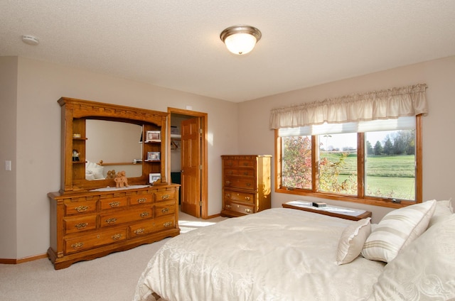 carpeted bedroom with a textured ceiling