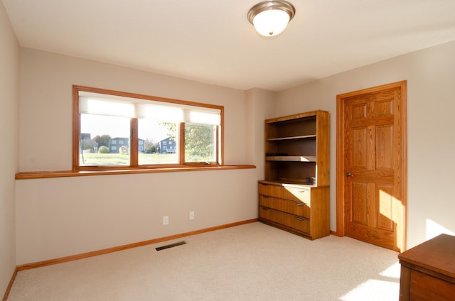 unfurnished bedroom featuring light colored carpet