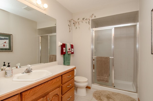 bathroom featuring vanity, tile patterned floors, toilet, and an enclosed shower