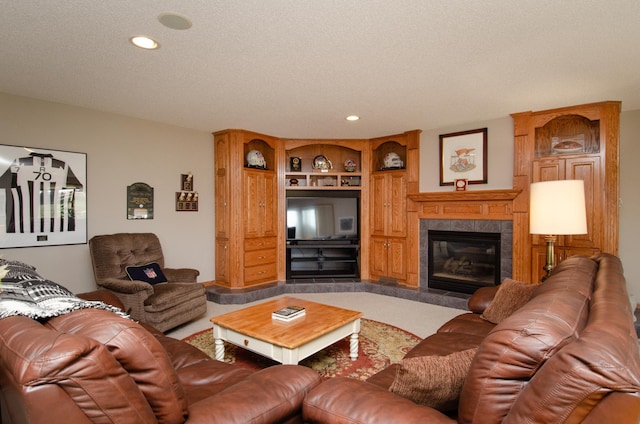 living room featuring a textured ceiling, a fireplace, and built in features