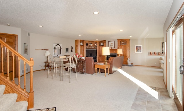 carpeted dining space with a textured ceiling