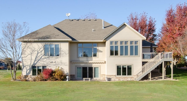 rear view of property featuring a wooden deck and a yard