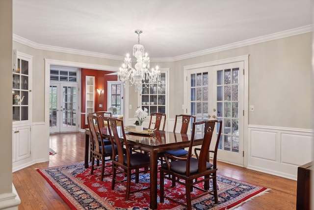 dining room featuring ornamental molding, french doors, and hardwood / wood-style floors