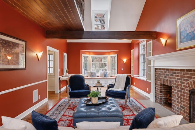 living room featuring light wood-type flooring, beam ceiling, and a fireplace