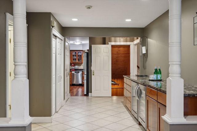 kitchen with dark stone counters, light hardwood / wood-style flooring, and stainless steel appliances