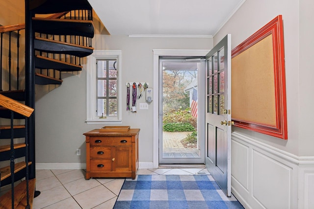 entrance foyer featuring plenty of natural light, light tile patterned floors, and crown molding