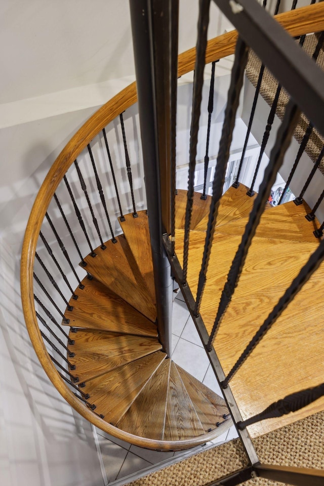 stairway with tile patterned floors