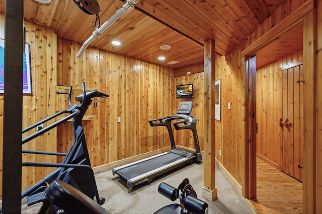 exercise room featuring wood-type flooring, wooden walls, and wooden ceiling