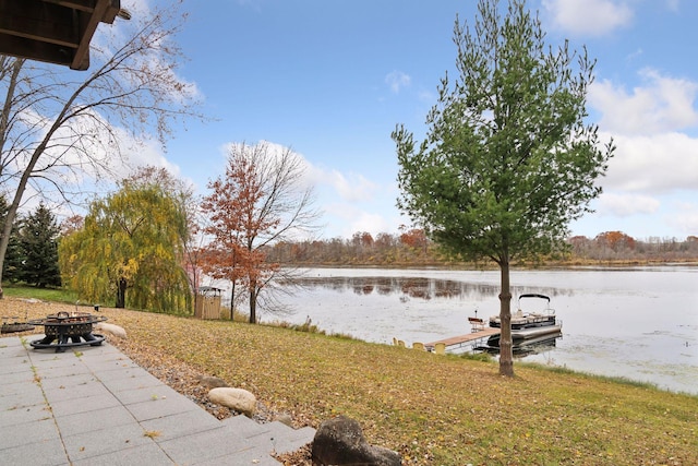 dock area with an outdoor fire pit and a water view