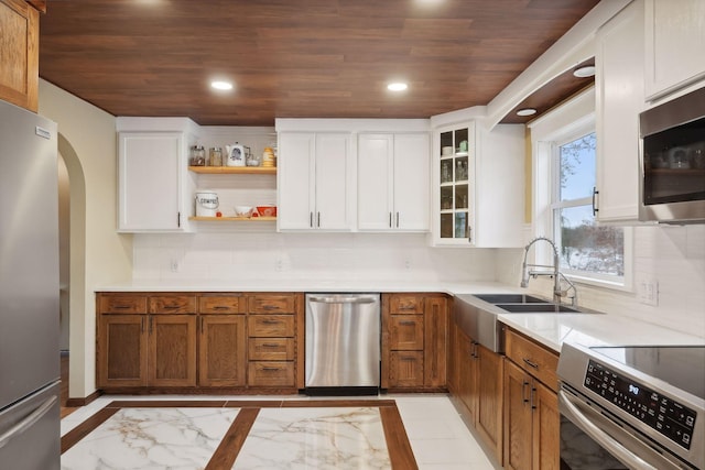 kitchen featuring wooden ceiling, white cabinetry, sink, and stainless steel appliances