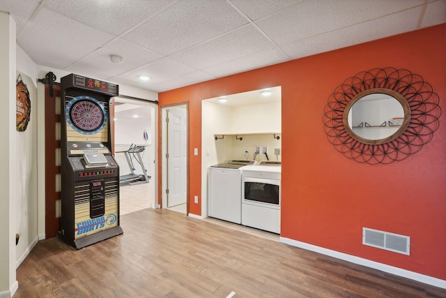 washroom featuring hardwood / wood-style floors and independent washer and dryer