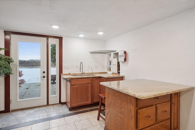 bar with sink and a water view