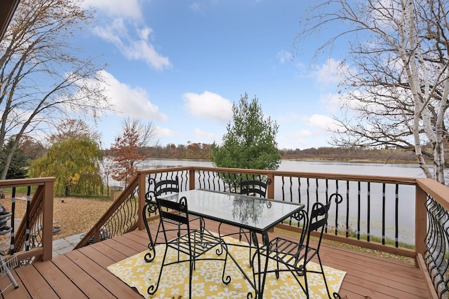 wooden terrace featuring a water view