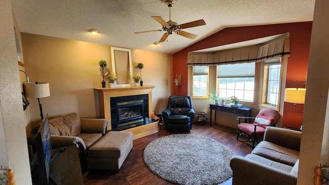 living room with dark wood-type flooring, ceiling fan, a textured ceiling, and lofted ceiling