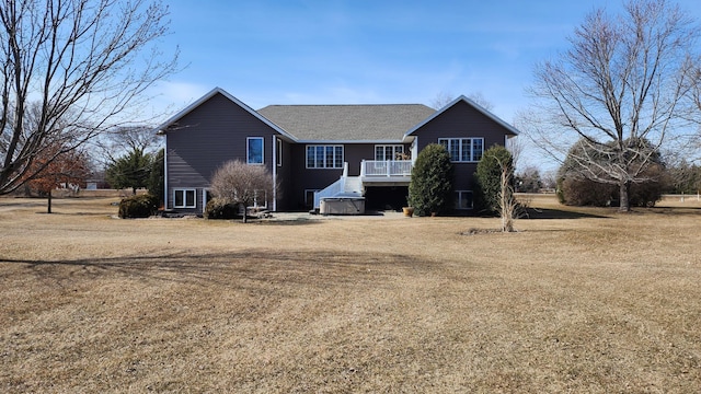 view of front facade with a deck and a front lawn