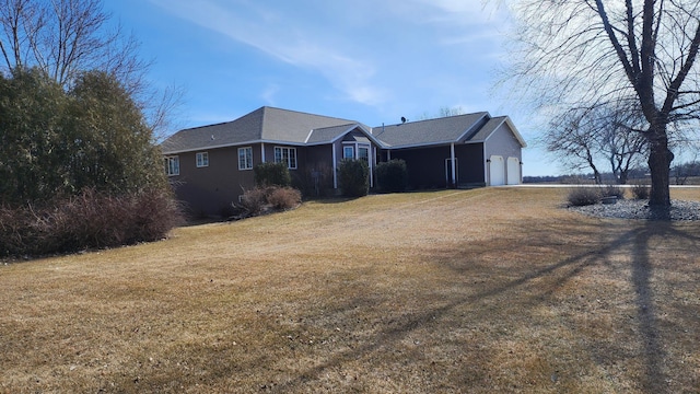 view of front of home with a front lawn and a garage