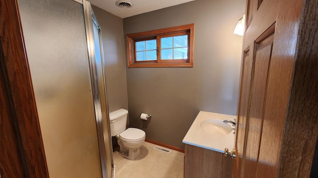 bathroom featuring toilet, an enclosed shower, a textured ceiling, and vanity