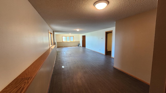 corridor featuring dark hardwood / wood-style floors and a textured ceiling