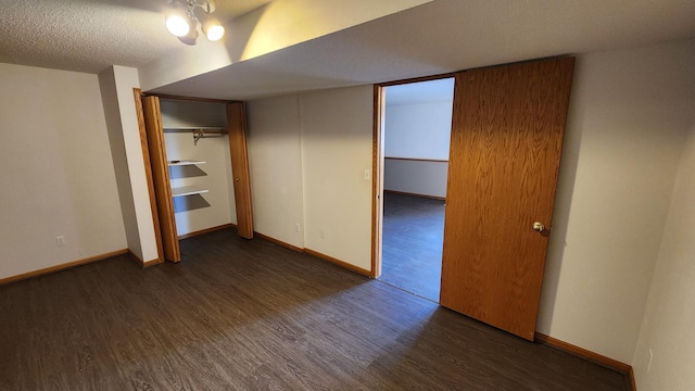 unfurnished bedroom with dark wood-type flooring, a closet, and a textured ceiling