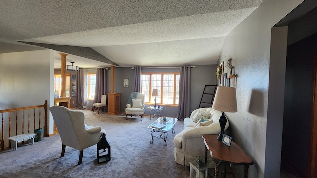 living room with decorative columns, a textured ceiling, carpet, and lofted ceiling