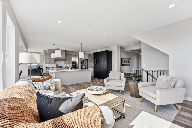 living room featuring light hardwood / wood-style flooring and sink