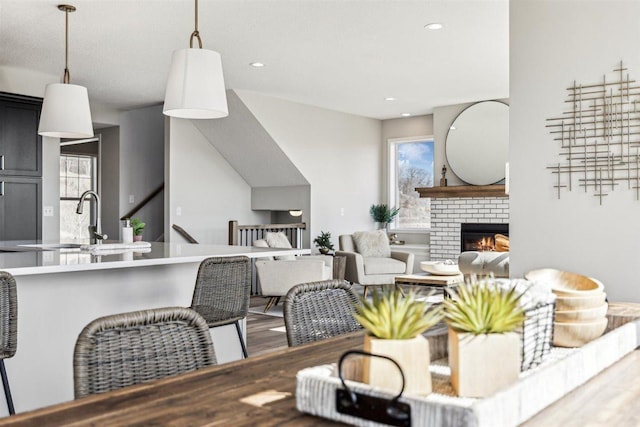 living room with a fireplace, wood-type flooring, and sink