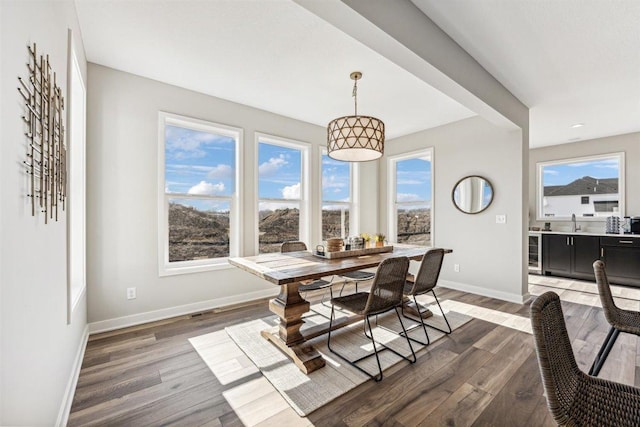 dining area featuring dark hardwood / wood-style flooring, sink, and wine cooler