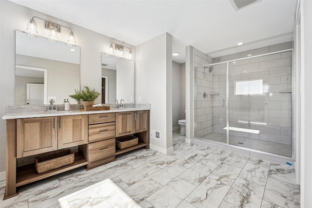 bathroom featuring vanity, a shower with shower door, and toilet