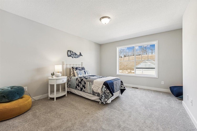 bedroom with carpet flooring and a textured ceiling