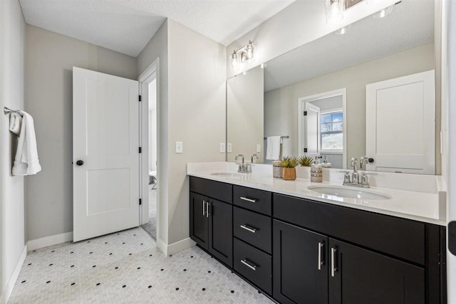 bathroom featuring vanity and a textured ceiling