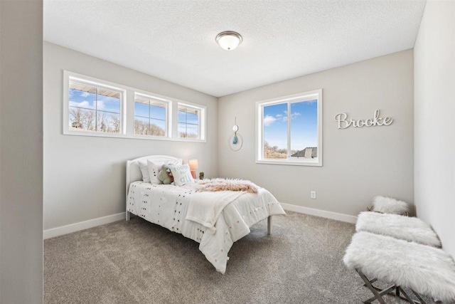 carpeted bedroom with a textured ceiling