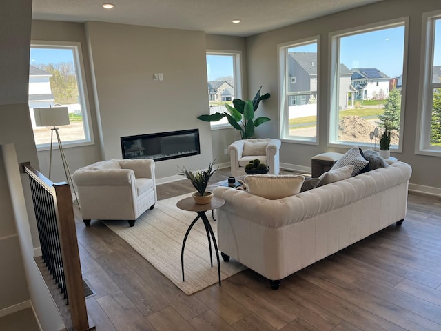 15701 Aquila Ave, Savage, MN 55378 - living room featuring baseboards, recessed lighting, a healthy amount of sunlight, and hardwood / wood-style floors