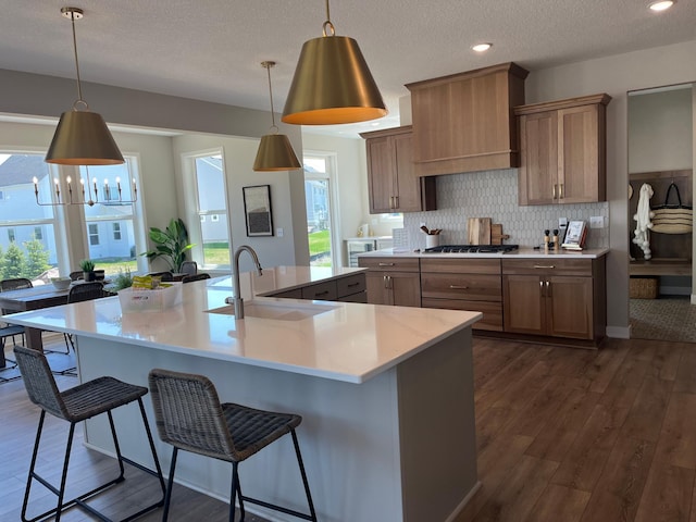 15701 Aquila Ave, Savage, MN 55378 - kitchen featuring light countertops, a large island with sink, custom exhaust hood, and a sink
