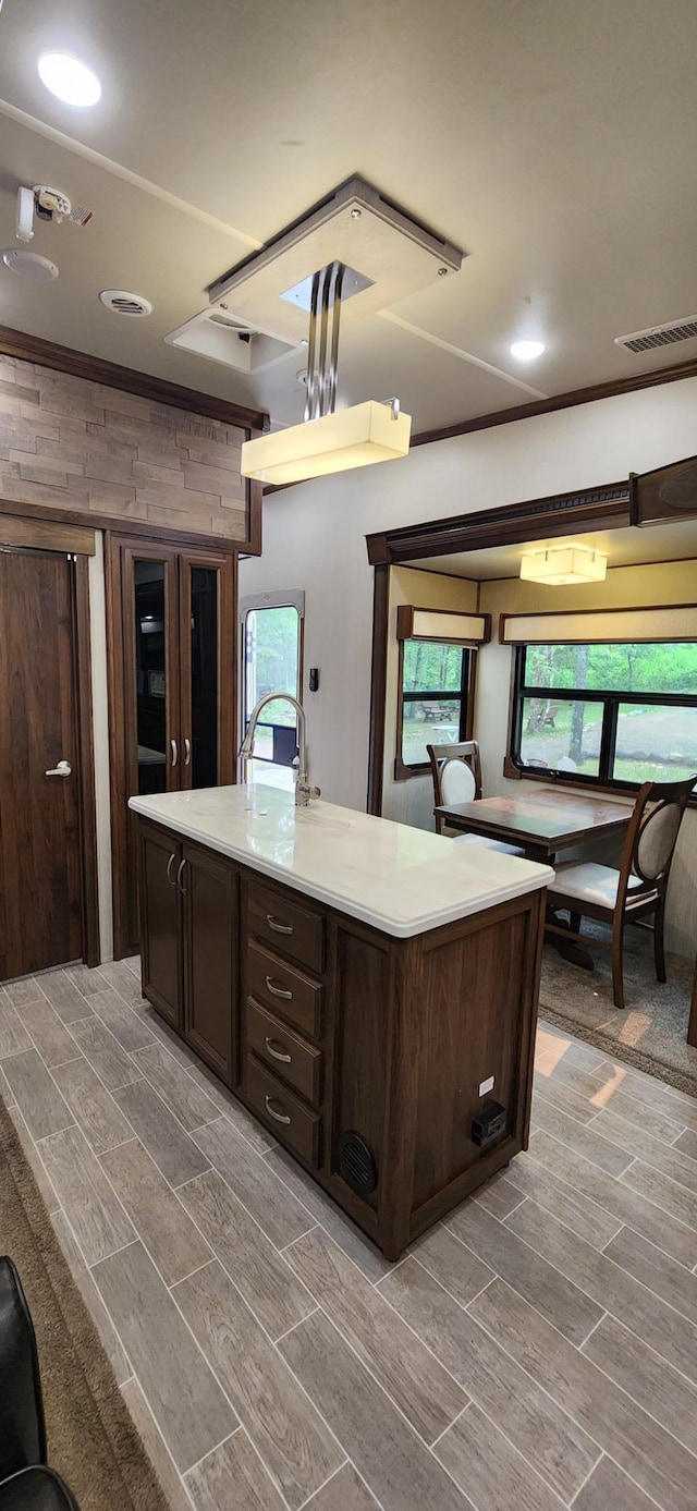 3736 Silent Springs Ct, Webb Lake, WI 54830 - kitchen featuring visible vents, dark brown cabinetry, wood finish floors, and plenty of natural light