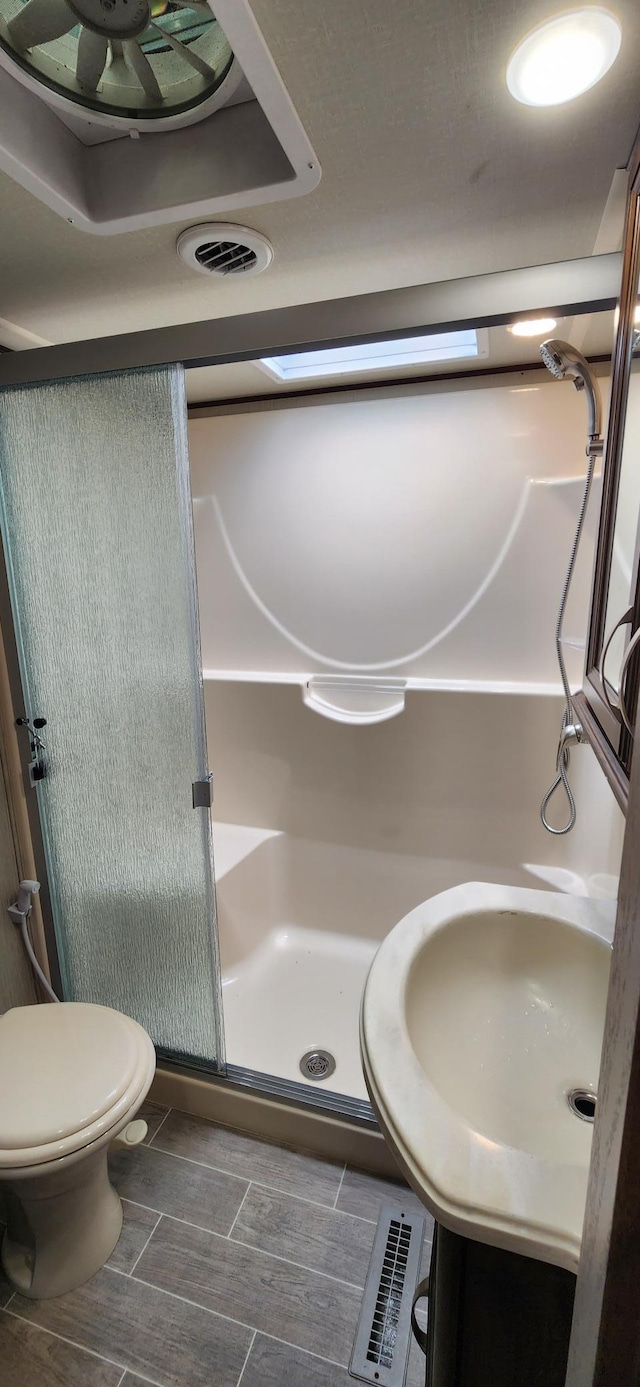 3736 Silent Springs Ct, Webb Lake, WI 54830 - full bathroom with toilet, visible vents, a shower stall, and a sink