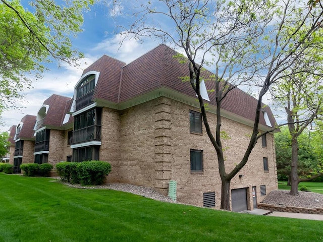 view of property exterior with a lawn and a garage