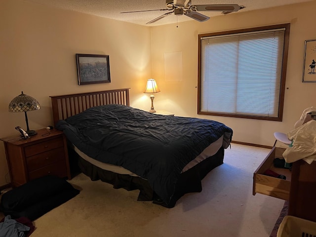 bedroom featuring light carpet, a textured ceiling, and ceiling fan