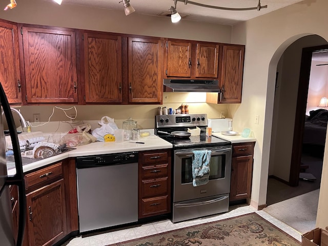 kitchen with appliances with stainless steel finishes and rail lighting