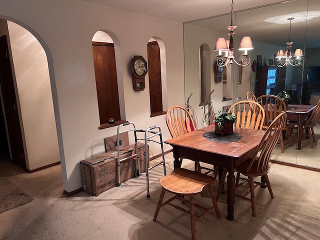 dining area with an inviting chandelier