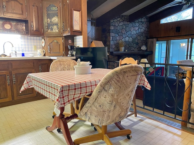 kitchen featuring vaulted ceiling with beams and sink