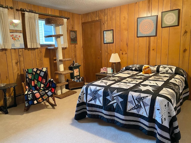 bedroom with carpet flooring, a textured ceiling, and wooden walls