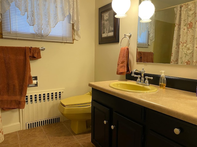 bathroom featuring vanity, toilet, radiator heating unit, and tile patterned flooring