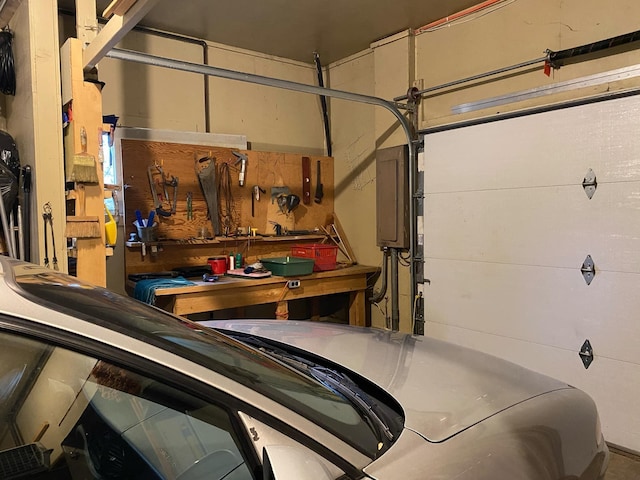 garage with electric panel and a workshop area