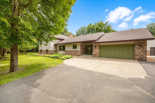 view of front facade with a front lawn and a garage