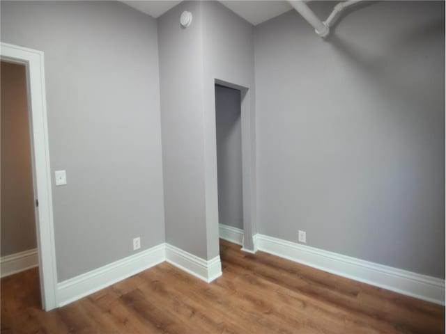 empty room featuring wood-type flooring